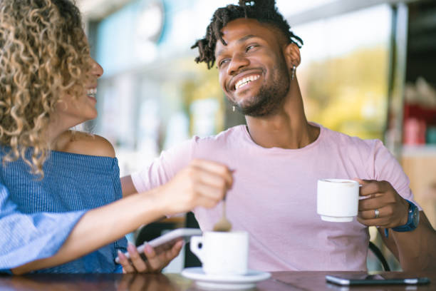istock Young couple drinking coffee at a coffee shop. 1331113090