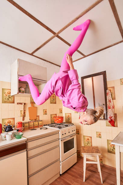 istock Woman standing topsy-turvy at ceiling and looking down while spending time at the kitchen 1331114141
