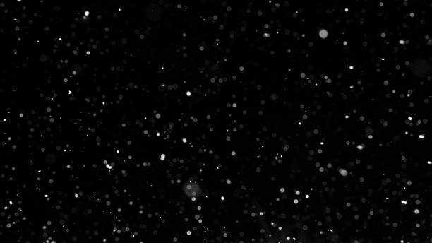 istock Bokeh of white snow on a black background. Snowfall - design element. 1331114365