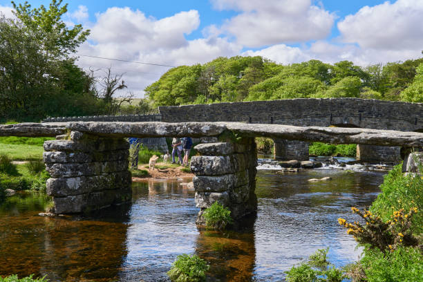 istock Medieval clapper bridge over the East Dart River at Postbridge on Dartmoor in Devon, West Country, England, UK 1331124936