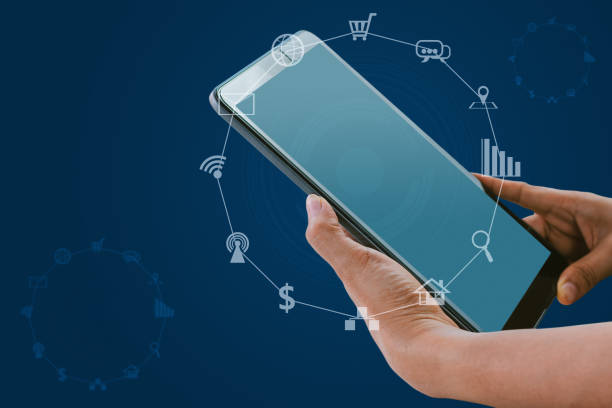 istock Hand holding tablet with blurred social media and technology icons 1331125922