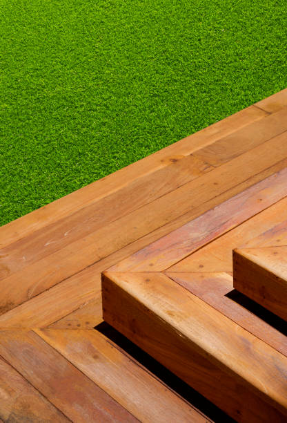 istock Outdoors wooden steps on green artificial turf in front yard area at home 1331126373
