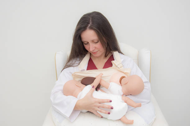 woman professional nurse teaching breastfeeding