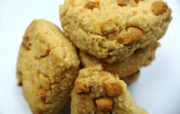 istock Home made sweet biscuits with mixed nuts on white background 1331128674