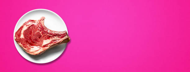 istock Beef prime rib and plate isolated on pink background. Horizontal banner 1331130948