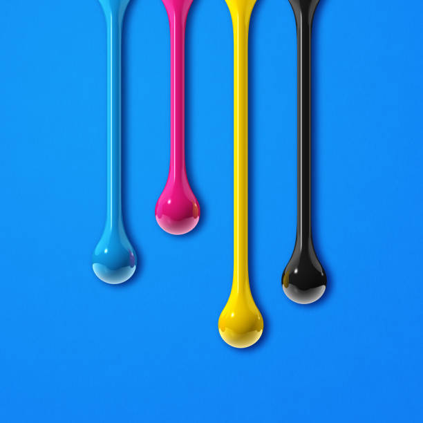 istock cmyk ink drops on blue paper square background 1331131107