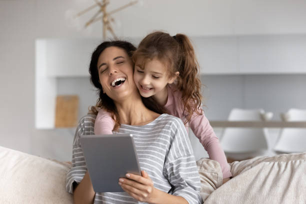 istock Happy young Latino mom and daughter use tablet 1331134322