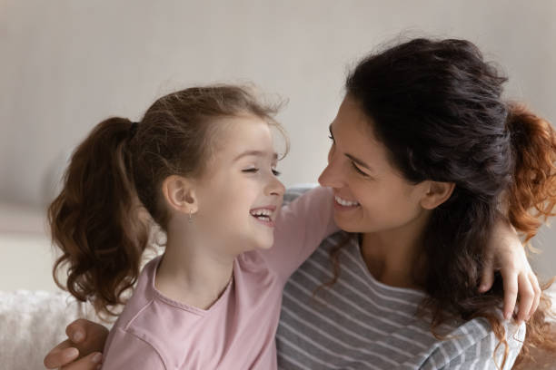 istock Smiling Latin mom and small daughter relax hugging 1331134333