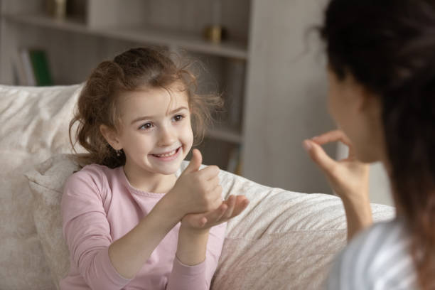 istock Smiling girl child talk using sign language 1331134341