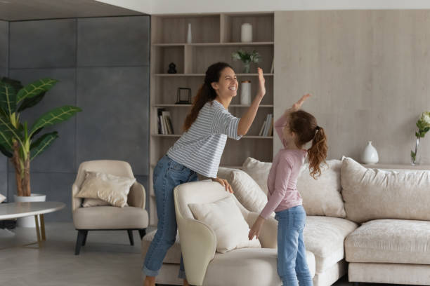 istock Smiling Hispanic mom and daughter give high five five 1331134367