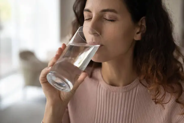 Photo of Thirsty Latin woman drink clean cold water
