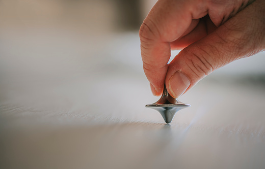 Spinning toy Gyroscope Die Cast Spinning Top on hardwood flooring