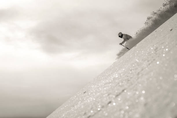 istock Backcountry skier descends snowy mountain ridge 1331139538
