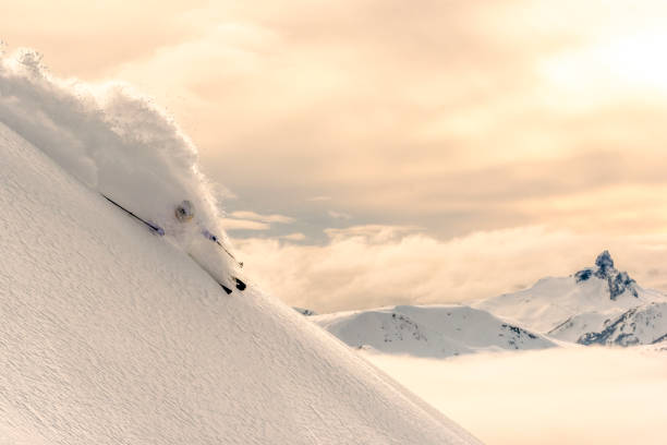istock Backcountry skier descends snowy mountain ridge 1331139580