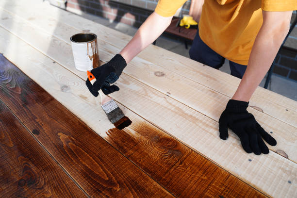 istock hand holding a brush applying varnish paint on a wooden surface 1331142137