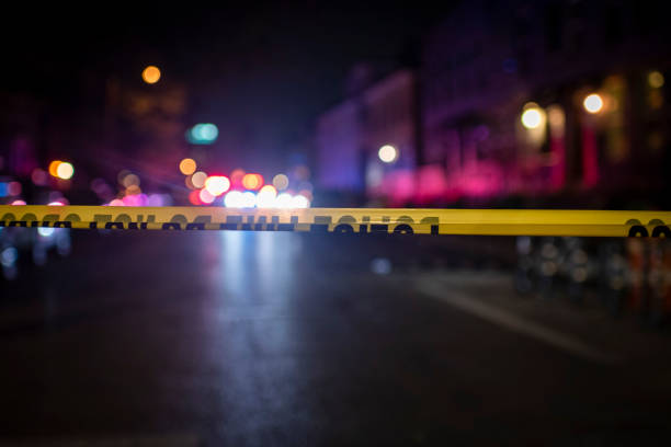 Crime Scene Police tape delineates crime scene barricade tape stock pictures, royalty-free photos & images