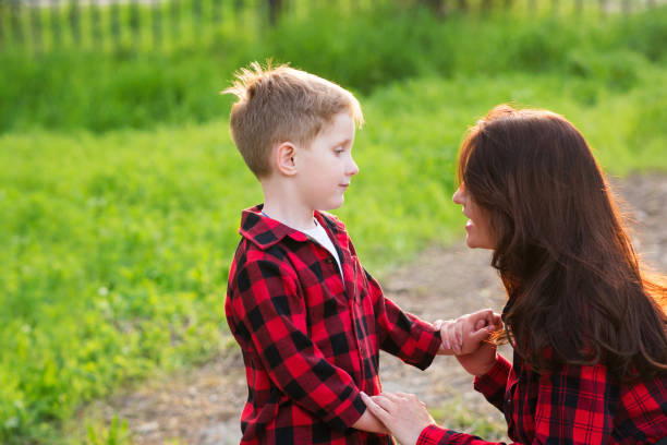 istock Mom with little son walking in park 1331144838