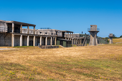 A view of an observation tower and a gun emplacement at Fort Casey State Park on Whidbey Island in Washington State.  This is a very popular tourist attraction on the island.  Its original intent was to guard the entrance to Puget Sound. It was part, of what is called, \