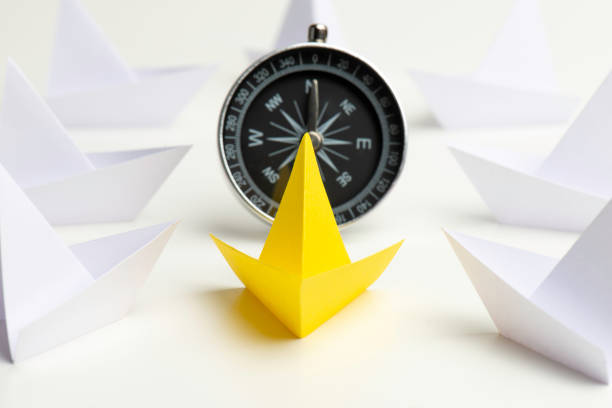 istock Yellow Paper Boat With Compass 1331148216