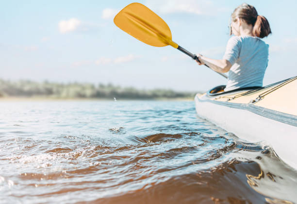 istock Woman explorer floats on the river on a boat. 1331150895
