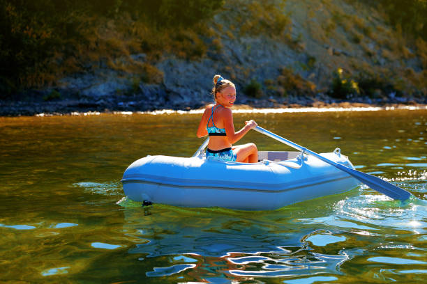 Young girl enjoying on boat during summer vacation.
