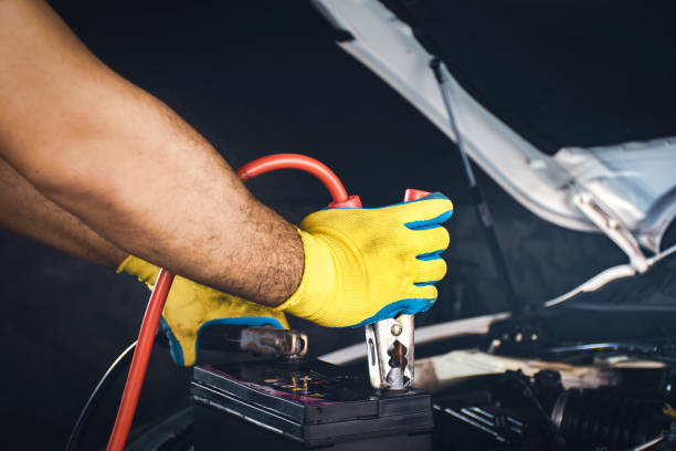 istock Technician clamping the charger cable to the car battery 1331156103