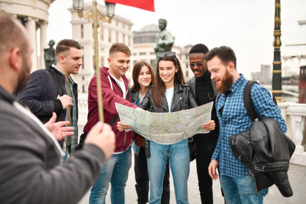 istock Female Asking Tour Guide About Different Places Located On Map 1331160354