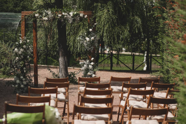 istock Wedding arch on boho style with white flowers in park. 1331160476