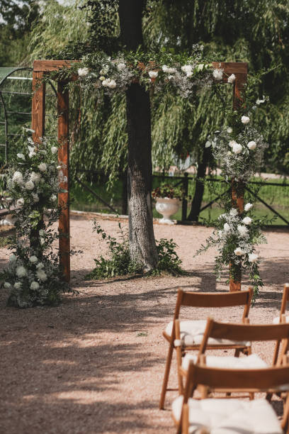istock Wedding arch on boho style with white flowers in park. 1331160509