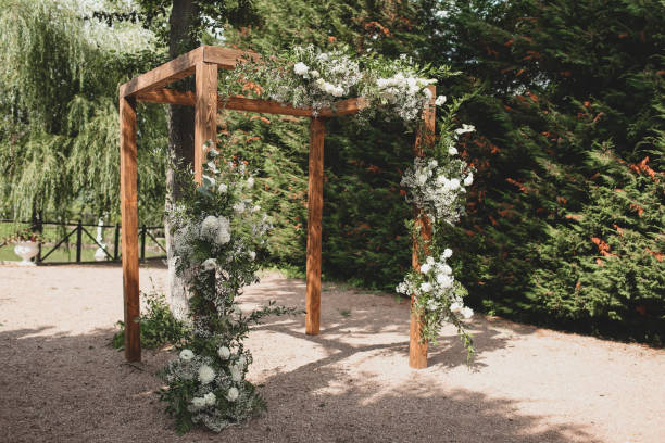 istock Wedding arch on boho style with white flowers in park. 1331160652