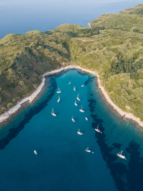 Sailboats anchored in beautiful bay from above stock photo