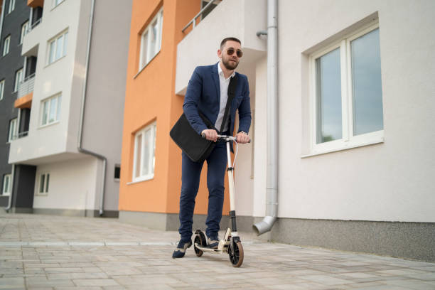 istock Happy hipster with drink riding scooter 1331162482