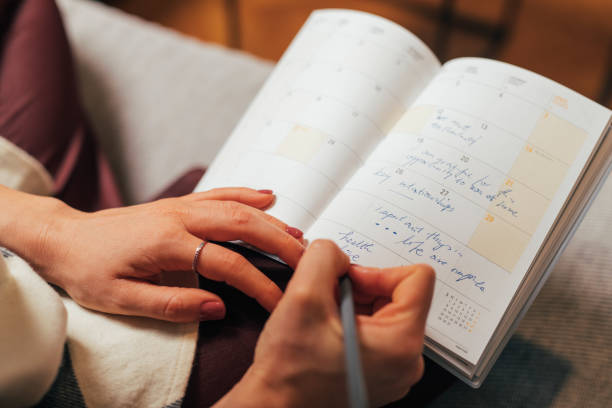 istock Anonymous Caucasian Woman Sitting on the Couch and Taking Notes 1331166341
