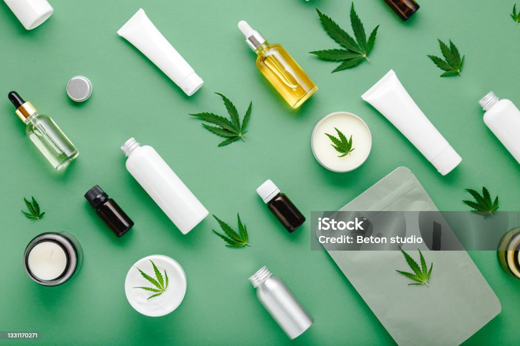Hemp cbd oil serum in glass dropper bottle with cannabis leaves, Moisturizing cream, Serum, lotion, essential oil. Cannabis leaf with skincare cosmetic product Flat lay pattern on green background Hemp cbd oil serum in glass dropper bottle with cannabis leaves, Moisturizing cream, Serum, lotion, essential oil. Cannabis leaf with skincare cosmetic product Flat lay pattern on green background. Cannabidiol Stock Photo