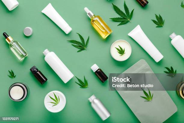 Hemp Cbd Oil Serum In Glass Dropper Bottle With Cannabis Leaves Moisturizing Cream Serum Lotion Essential Oil Cannabis Leaf With Skincare Cosmetic Product Flat Lay Pattern On Green Background Stock Photo - Download Image Now