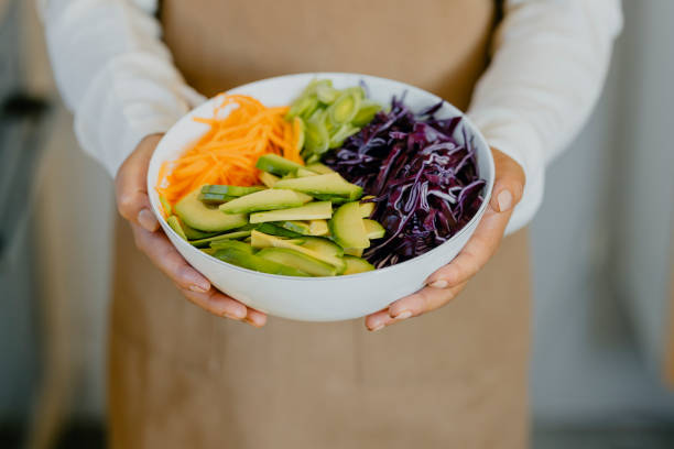 istock Anonymous Female Chef Holding a White Bowl with Fresh Vegetables 1331171125