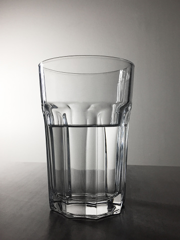 Half full glass of water on the table