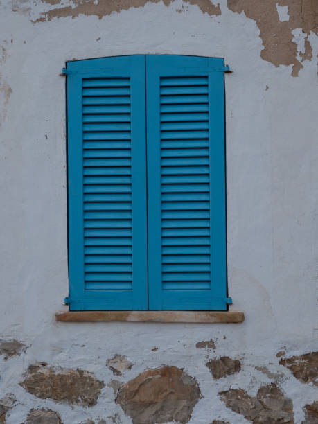 istock Light blue shutters on a Mediterranean style house 1331173246