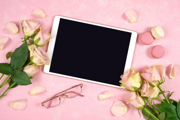 istock Desktop workspace tablet mockup flatlay, blush pink roses on pink background. 1331173513