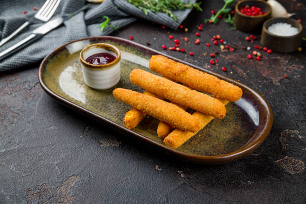 istock fried Cheese sticks on dark brown plate with berry sause on dark concrete table 1331174296