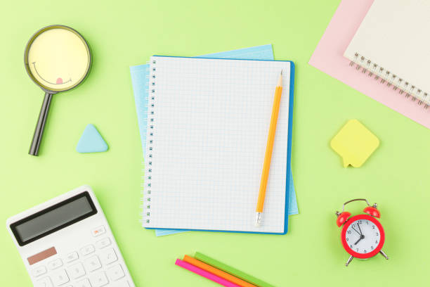 istock Open spiral notebook with school supplies 1331177734