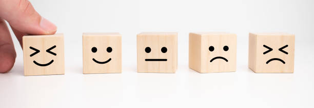 istock Customer service evaluation and satisfaction survey concepts. The client's hand picked the happy face smile face symbol on wooden cube, copy space 1331178518