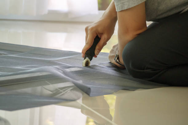 istock man install mosquito net wire screen on house window protection against insect 1331184436