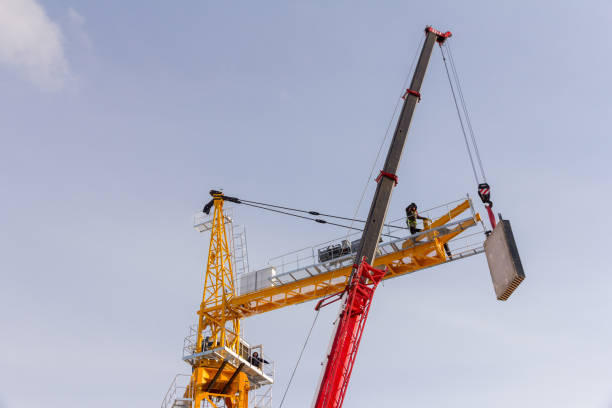 istock Construction crane assembly stage. Tower crane assembly. Installation of a construction crane before starting construction. 1331184583
