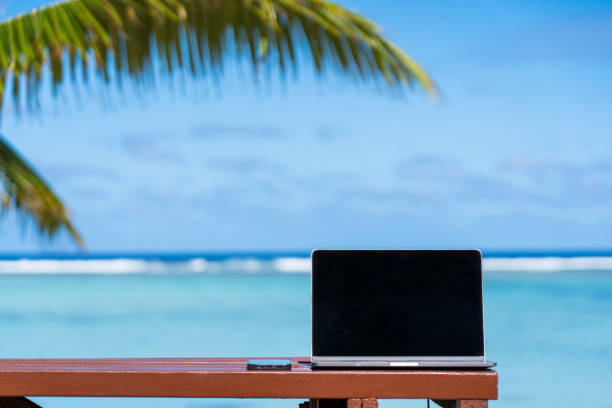 istock Laptop sitting on beach table, remote freelance working, Cook Islands, Rarotonga 1331196571