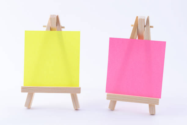 istock Two Wooden Easels Miniature with Blank Colored Square Canvas or Memo Paper 1331200975