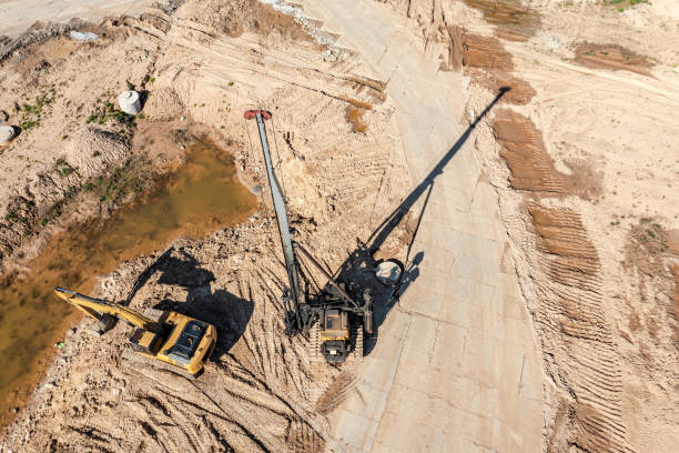 istock heavy construction machinery - excavator and pile driver - on construction site. aerial drone view 1331201330