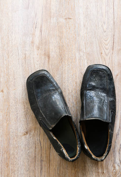 istock old vintage leather shoe put on wooden table top 1331203679