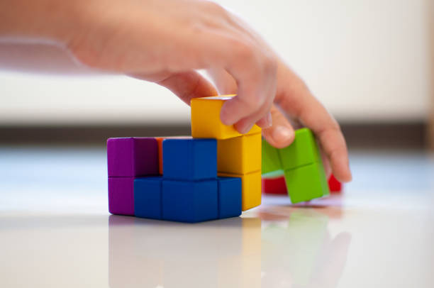 istock Child plays with wooden blocks on the floor. 1331205840