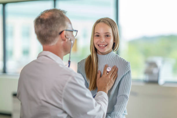 istock Elementary aged girl visits the doctor 1331206798